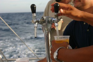 Man pouring himself a beer while on a boat